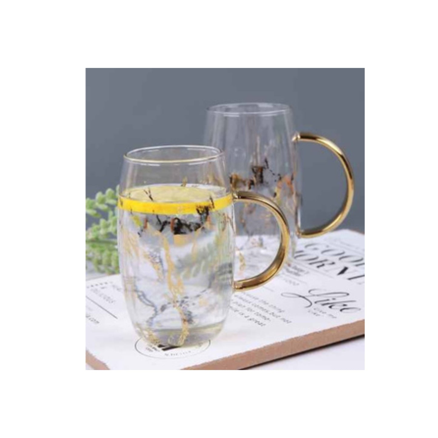 Glass mug with golden handle