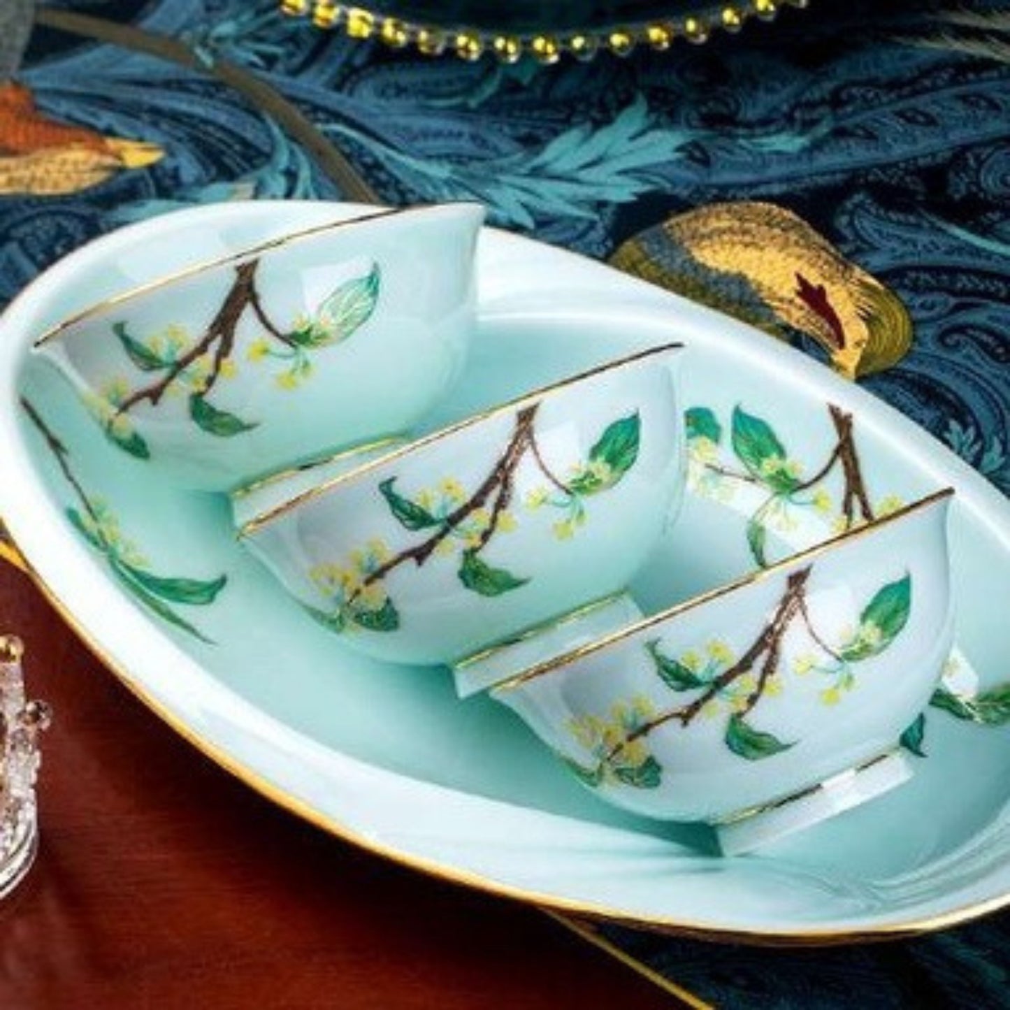 Golden Autumn Osmanthus porcelain crockery set with light blue base and green leaves and branches design