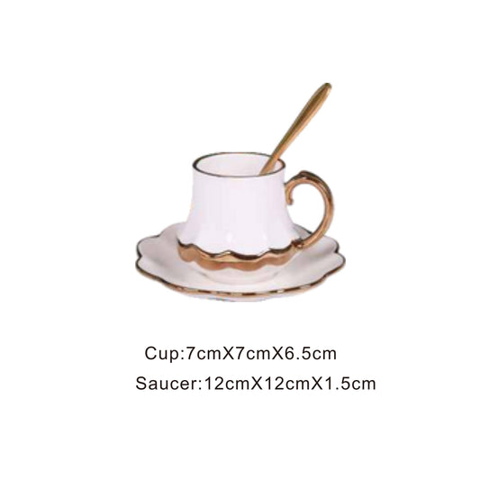 White ceramic cup and saucer set with golden pattern and handle