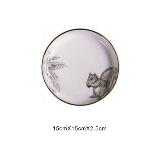 White ceramic round plate with animal face design, golden edges, and shiny surface