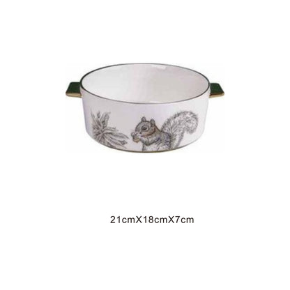White ceramic serving dish with moon pattern or animal face, golden edges, and shiny surface