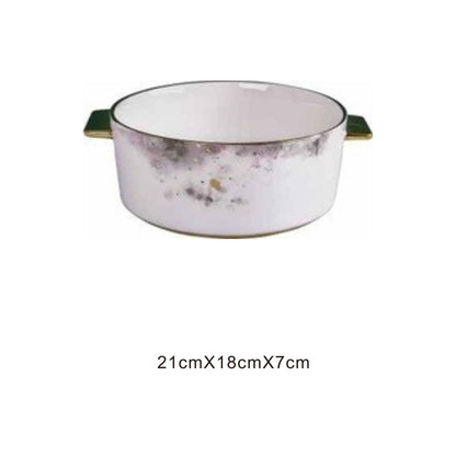 White ceramic serving dish with moon pattern or animal face, golden edges, and shiny surface