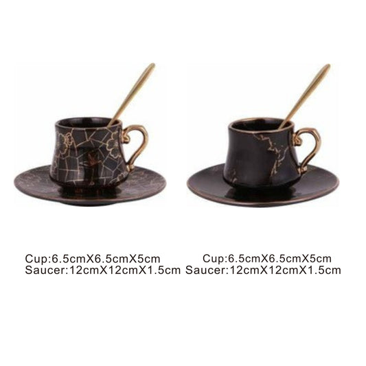 Black ceramic cup and saucer set with golden pattern and handle