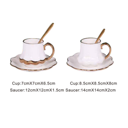 White ceramic cup and saucer set with golden pattern and handle