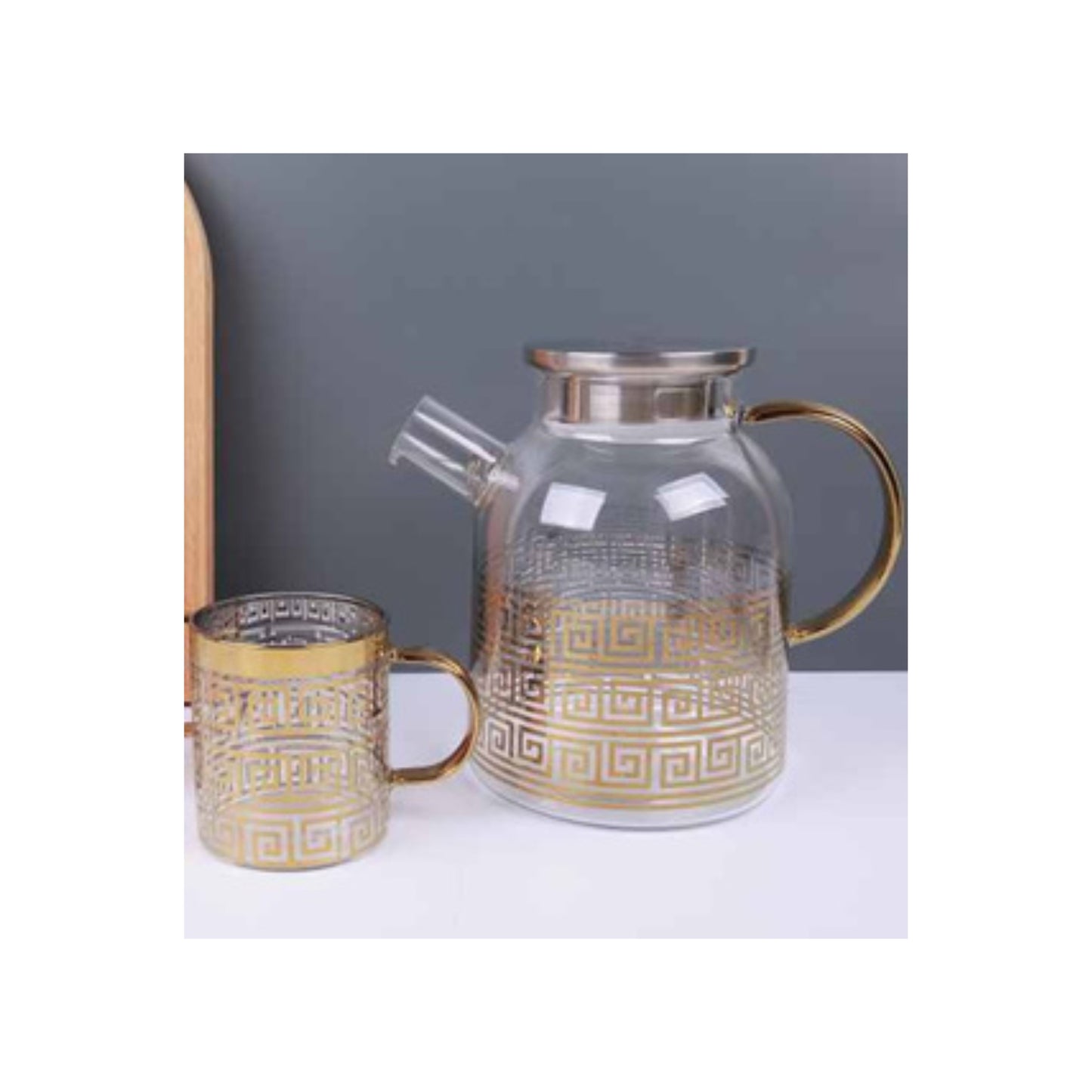 Glass teapot and mugs with metallic patterns in silver and gold