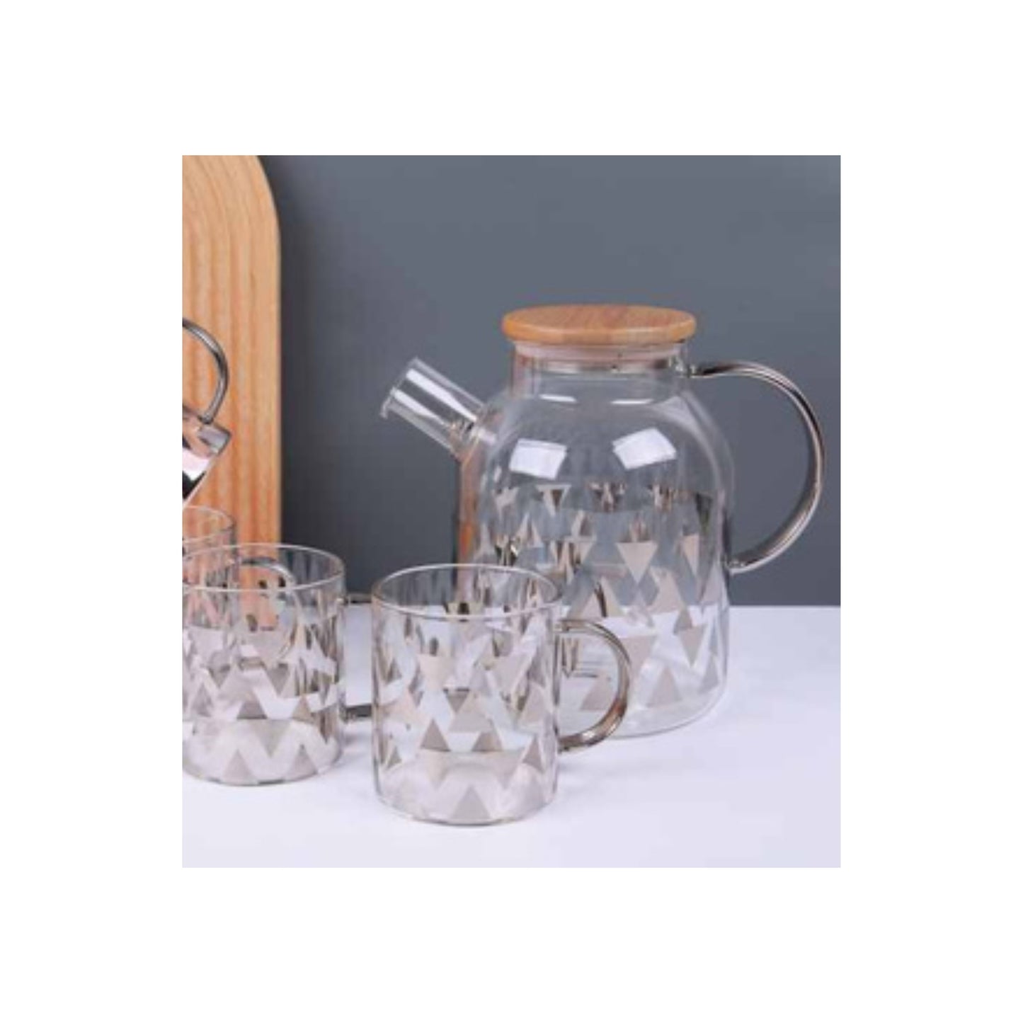Glass teapot and mugs with metallic patterns in silver and gold