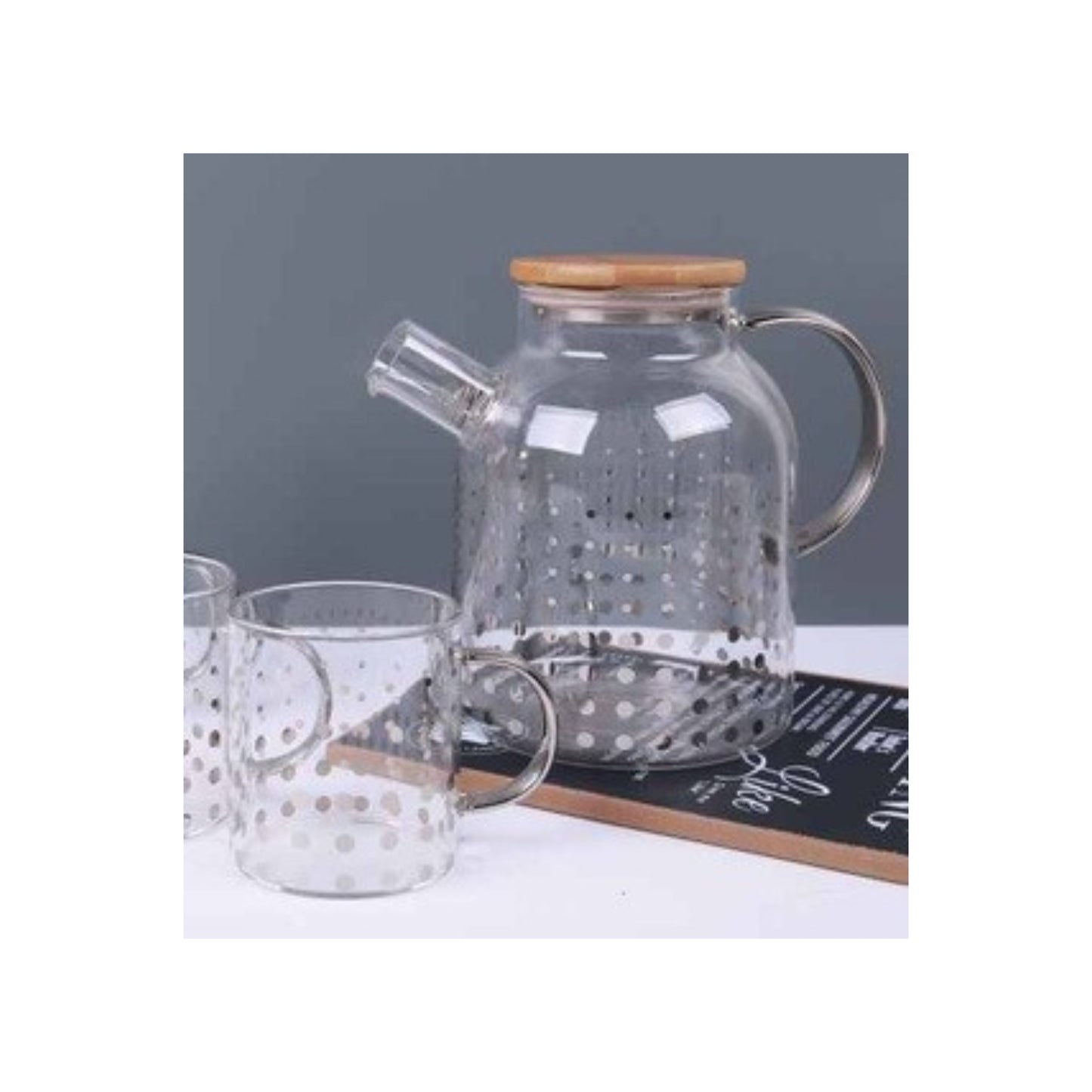 Glass teapot and mugs with metallic patterns in silver and gold
