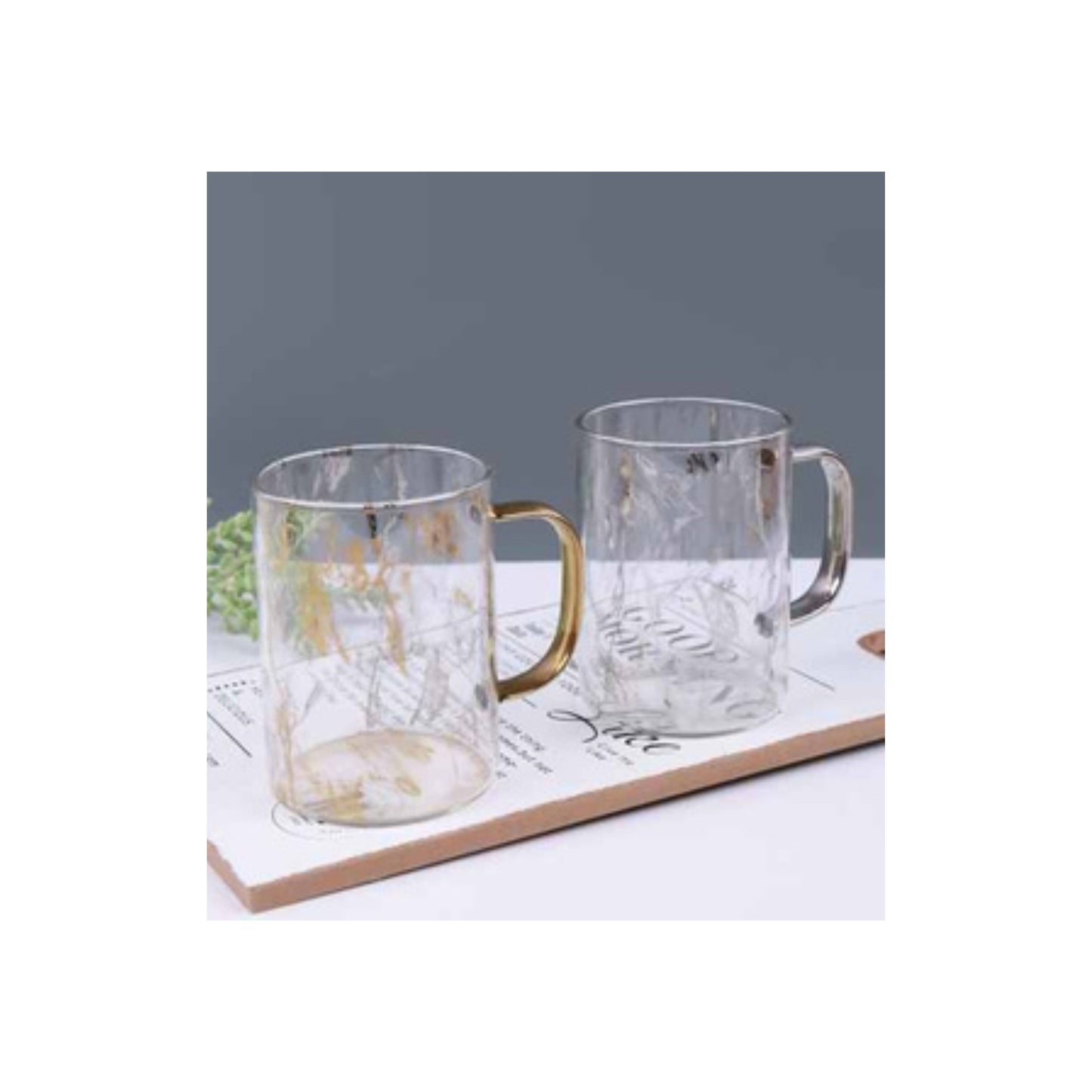 Glass mug with marble pattern and metallic handle in gold or silver