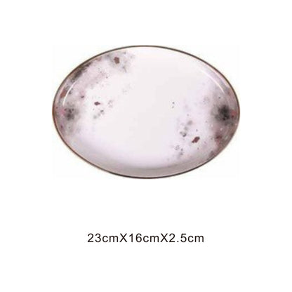 White ceramic plate with moon pattern, golden edges, and shiny surface