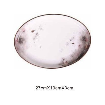White ceramic plate with moon pattern, golden edges, and shiny surface