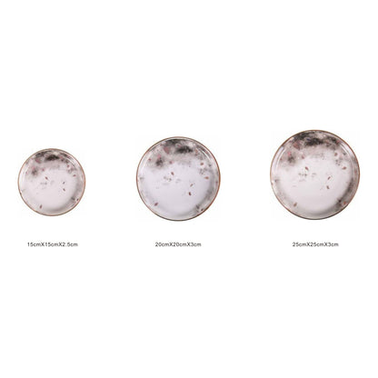 White ceramic round plate with moon pattern, golden edges, and shiny surface