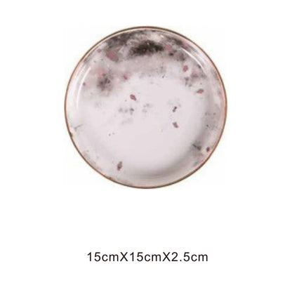 White ceramic round plate with moon pattern, golden edges, and shiny surface
