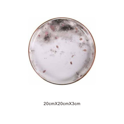 White ceramic round plate with moon pattern, golden edges, and shiny surface