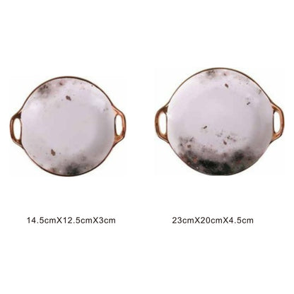 White ceramic irregular-shaped dish with moon pattern, golden edges, and shiny surface