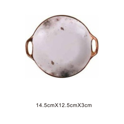 White ceramic irregular-shaped dish with moon pattern, golden edges, and shiny surface