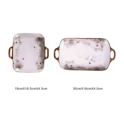 White ceramic serving dish with moon pattern, golden edges, and shiny surface