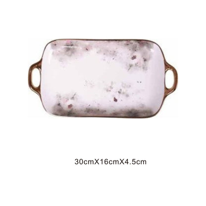 White ceramic serving dish with moon pattern, golden edges, and shiny surface