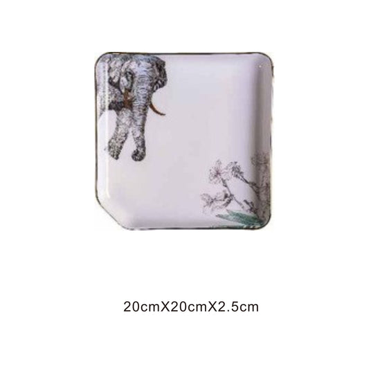 White ceramic square plate with animal face design, golden edges, and shiny surface