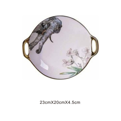 White ceramic round serving dish with animal face design, golden edges, and shiny surface