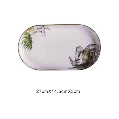 White ceramic pill-shaped serving dish with animal face design, golden edges, and shiny surface