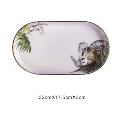White ceramic pill-shaped serving dish with animal face design, golden edges, and shiny surface