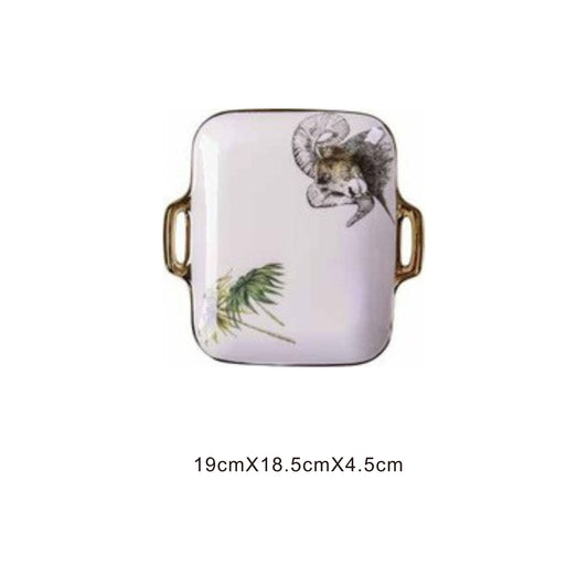 White ceramic rectangular serving dish with animal face design, golden edges, and shiny surface