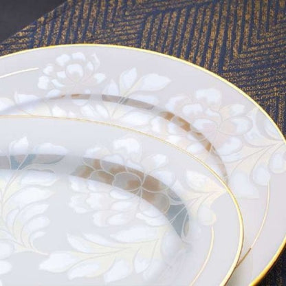 Delicate Elegance bone china crockery set with floral pattern, golden lines, and gilded edges