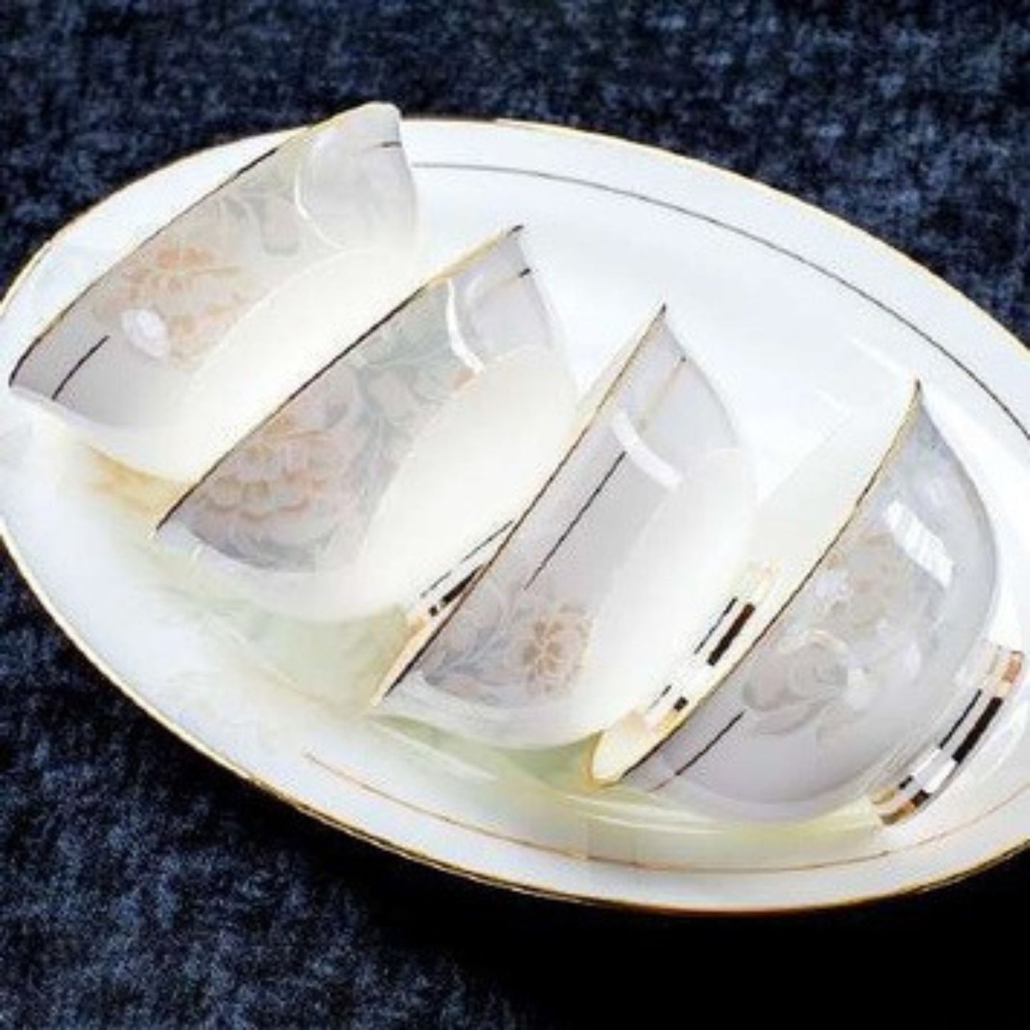 Delicate Elegance bone china crockery set with floral pattern, golden lines, and gilded edges