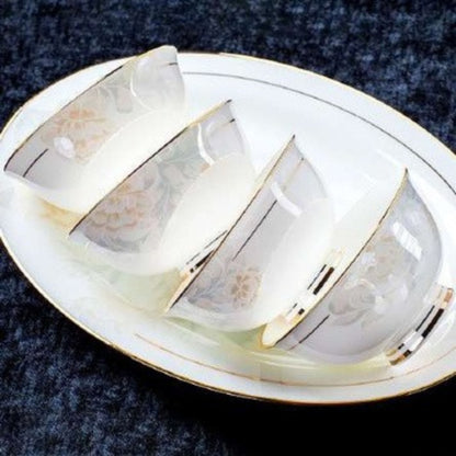 Delicate Elegance bone china crockery set with floral pattern, golden lines, and gilded edges