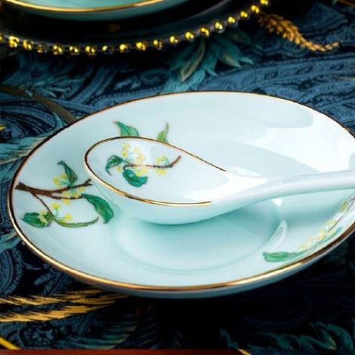 Golden Autumn Osmanthus porcelain crockery set with light blue base and green leaves and branches design