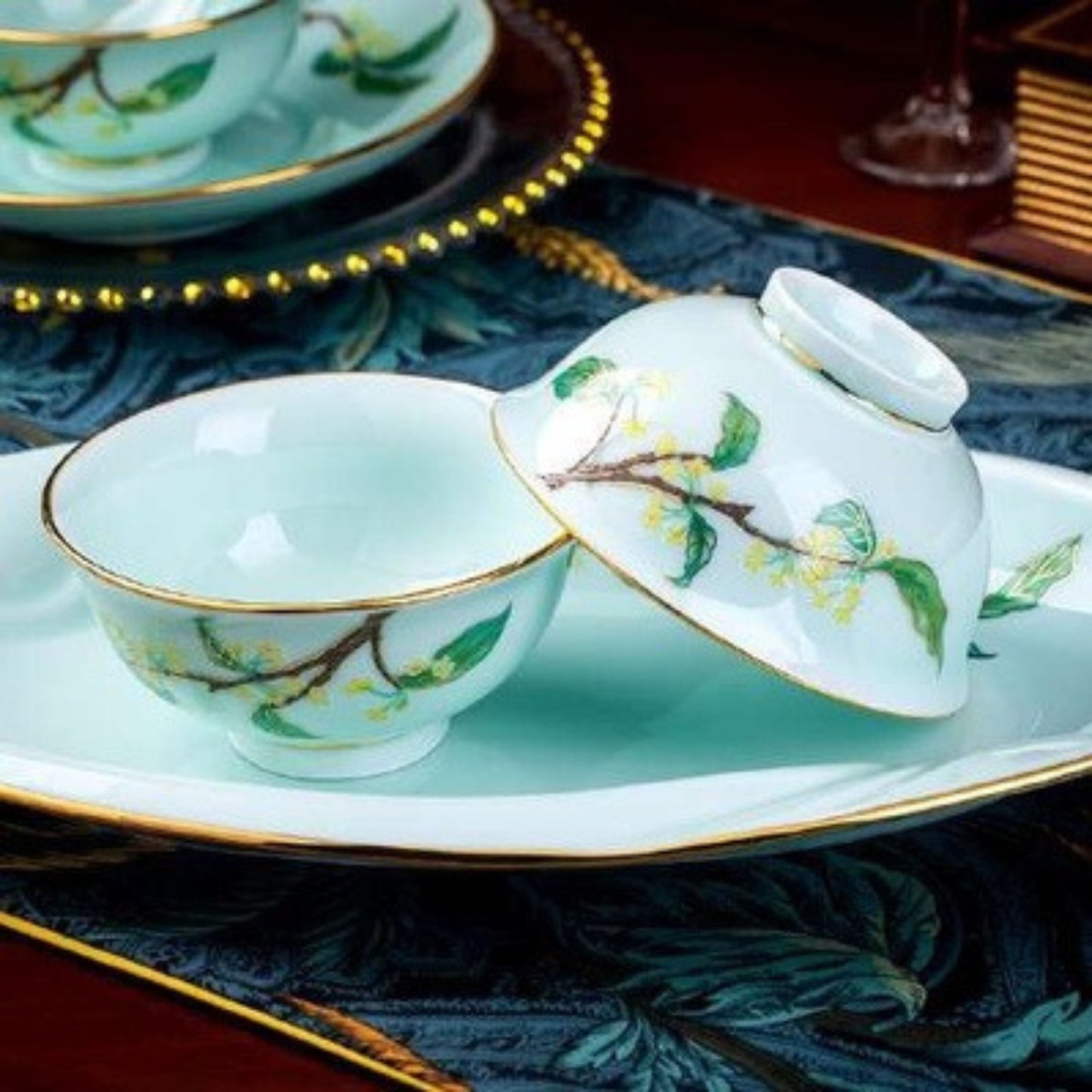 Golden Autumn Osmanthus porcelain crockery set with light blue base and green leaves and branches design